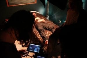 A still from the set of the short film Apparitions. The main actor laying in bed.