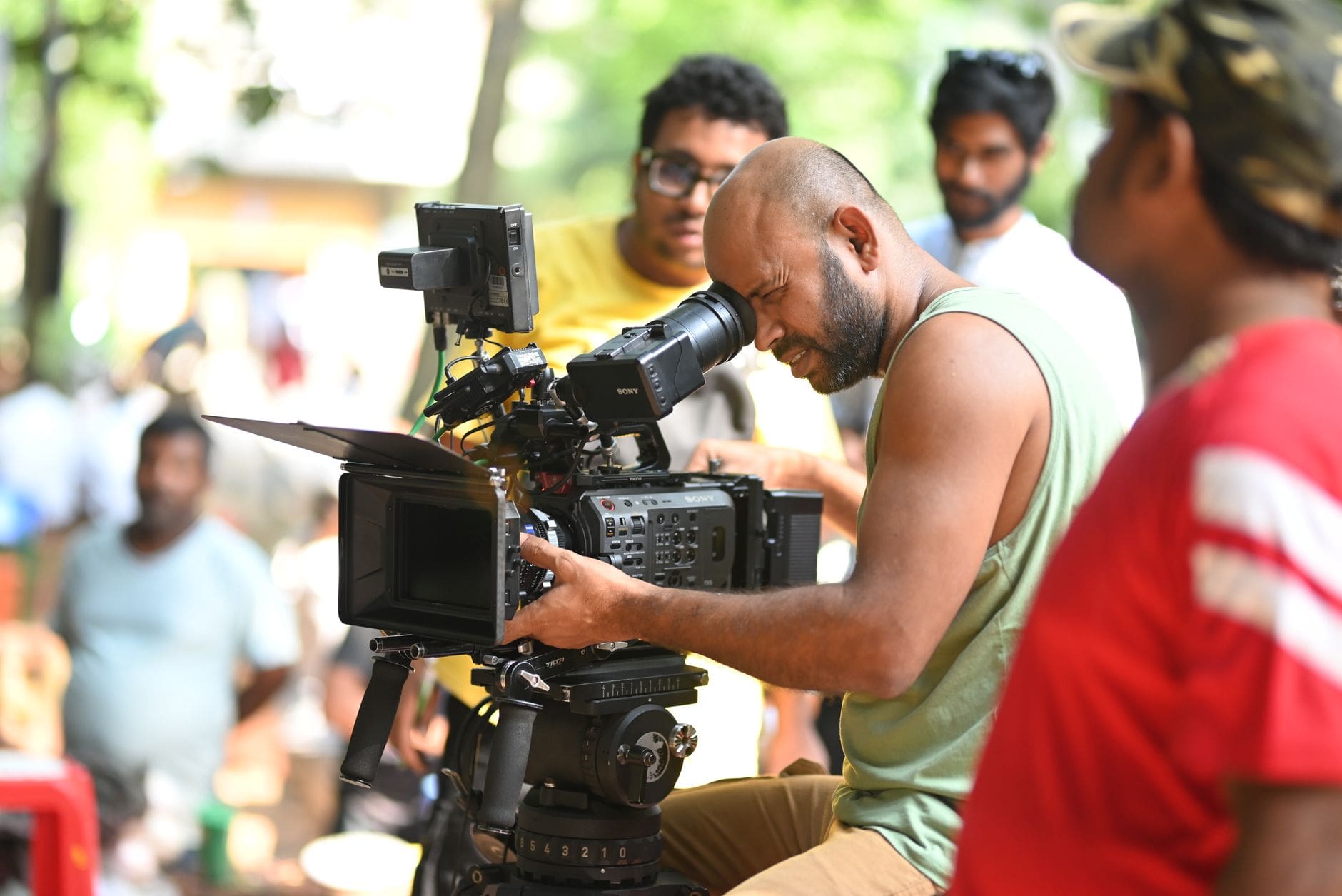 Best Cinema Cameras Under $5,000 in 2026: BMPCC 6K G2, Sony FX3, and Canon C70 Compared for Working Filmmakers 1 filmmaker operating cinema camera