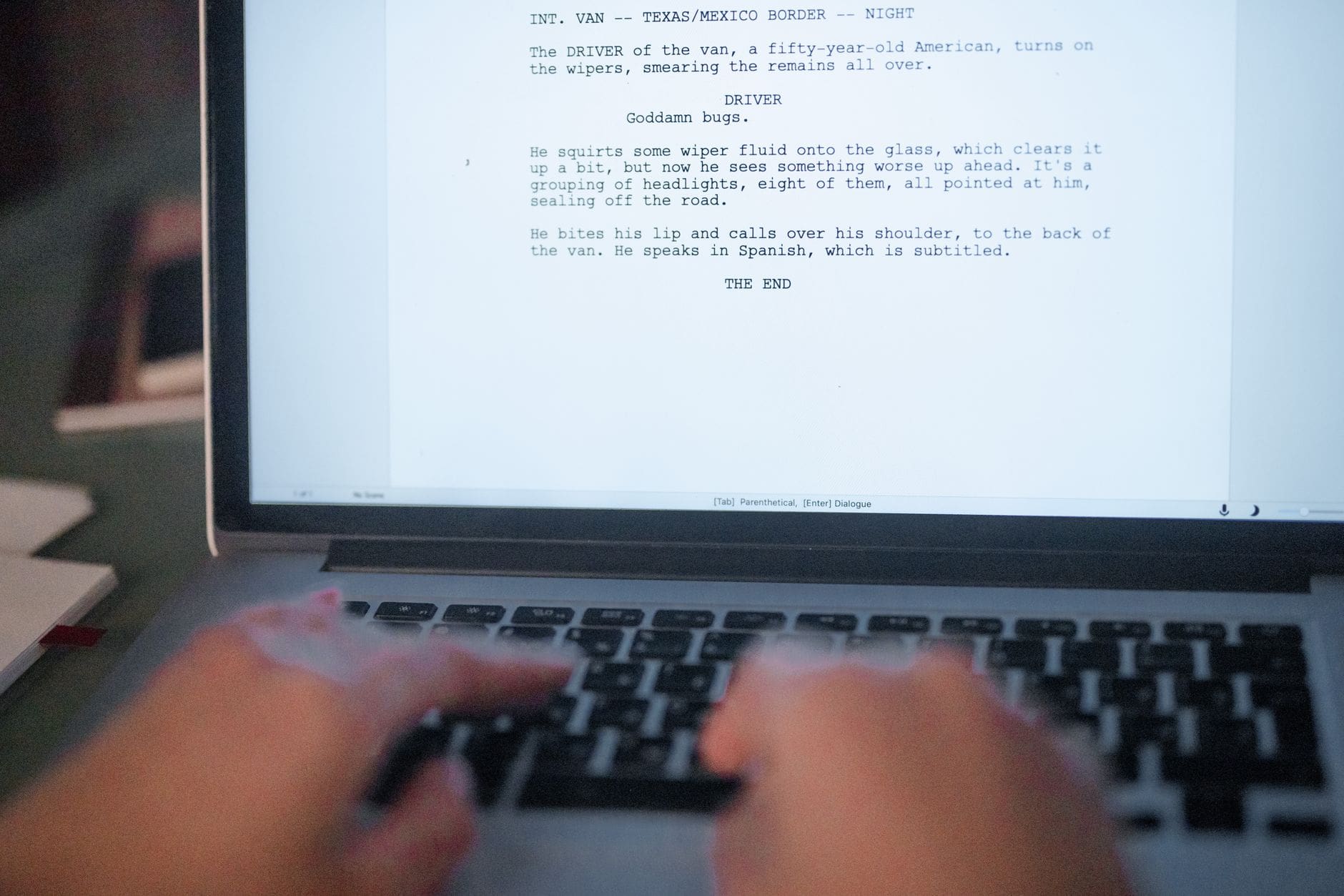 screenwriter working laptop office